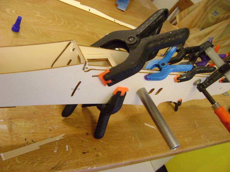 Hier zu sehen, die Rumpfseite Nummer2 wird aufgeleimt. Übrigens alles mit Holzleim. Gut zu sehen, die Pfeile zum einstellen der QR Hebel.